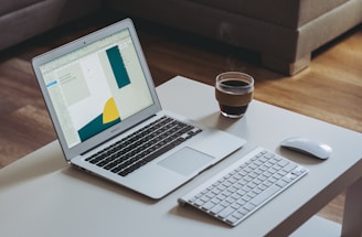A warm, inviting office space with a laptop open on a desk and a coffee cup beside it